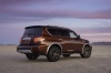 Picture of a 2017 Nissan Armada Platinum in Forged Copper from a rear right three-quarter perspective