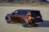 Picture of a 2017 Nissan Armada Platinum in Forged Copper from a rear left three-quarter top perspective