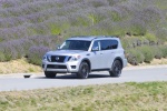 Picture of a driving 2017 Nissan Armada Platinum in Brilliant Silver from a front left three-quarter perspective