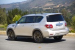 Picture of a driving 2017 Nissan Armada Platinum in Brilliant Silver from a rear left three-quarter perspective