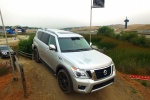 Picture of a driving 2017 Nissan Armada Platinum in Brilliant Silver from a front right perspective