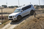 Picture of a driving 2019 Nissan Armada Platinum in Brilliant Silver from a front left three-quarter perspective