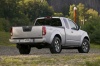 Picture of a 2014 Nissan Frontier King Cab PRO-4X 4WD in Brilliant Silver from a rear right three-quarter perspective