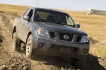 Picture of a driving 2014 Nissan Frontier Crew Cab PRO-4X 4WD in Night Armor from a front right perspective