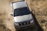 Picture of a driving 2014 Nissan Frontier Crew Cab PRO-4X 4WD in Night Armor from a frontal top perspective
