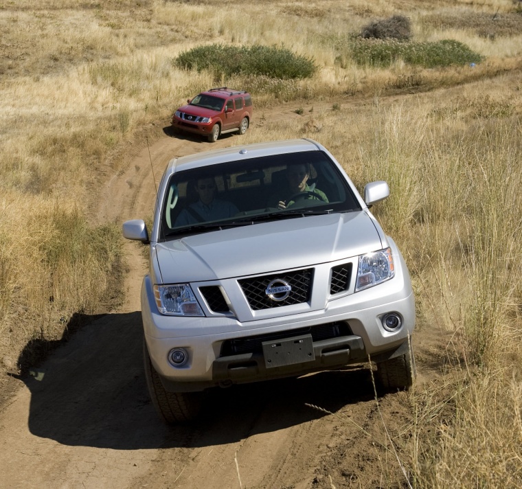 Picture of a driving 2015 Nissan Frontier King Cab PRO-4X 4WD in Brilliant Silver from a frontal perspective