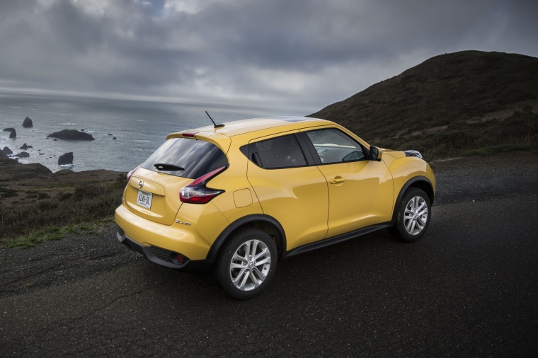 Picture of a 2015 Nissan Juke SL AWD in Solar Yellow from a rear right three-quarter perspective