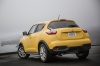Picture of a 2015 Nissan Juke SL AWD in Solar Yellow from a rear left perspective