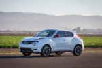 Picture of a driving 2016 Nissan Juke NISMO in White Pearl from a front left three-quarter perspective