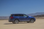 Picture of a driving 2018 Nissan Pathfinder Platinum 4WD in Caspian Blue from a rear right three-quarter perspective