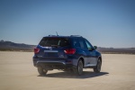 Picture of a driving 2019 Nissan Pathfinder Platinum 4WD in Caspian Blue Metallic from a rear right perspective