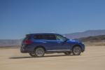 Picture of a driving 2019 Nissan Pathfinder Platinum 4WD in Caspian Blue Metallic from a rear right three-quarter perspective