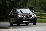 Picture of a driving 2019 Nissan Pathfinder Platinum 4WD in Mocha Almond Pearl from a front right perspective