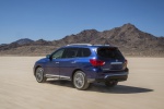 Picture of a driving 2020 Nissan Pathfinder Platinum 4WD in Caspian Blue Metallic from a rear left three-quarter perspective