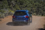 Picture of a driving 2020 Nissan Pathfinder Platinum 4WD in Caspian Blue Metallic from a rear right perspective