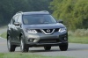 Picture of a driving 2014 Nissan Rogue SL AWD in Graphite Blue from a front right perspective