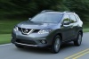 Picture of a driving 2014 Nissan Rogue SL AWD in Graphite Blue from a front left three-quarter perspective
