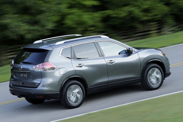 Picture of a driving 2015 Nissan Rogue SL AWD in Arctic Blue Metallic from a rear right three-quarter perspective