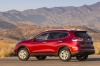 Picture of a 2015 Nissan Rogue SL AWD in Cayenne Red from a rear left three-quarter perspective