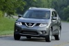 Picture of a driving 2015 Nissan Rogue SL AWD in Arctic Blue Metallic from a front left perspective