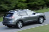 Picture of a driving 2016 Nissan Rogue SL AWD in Arctic Blue Metallic from a rear right three-quarter perspective