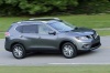Picture of a driving 2016 Nissan Rogue SL AWD in Arctic Blue Metallic from a front right three-quarter perspective