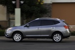 Picture of a driving 2014 Nissan Rogue Select in Platinum Graphite from a side perspective