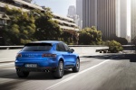 Picture of a driving 2015 Porsche Macan S in Dark Blue Metallic from a rear right perspective