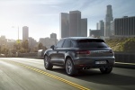 Picture of a driving 2015 Porsche Macan S in Agate Gray Metallic from a rear left three-quarter perspective