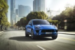 Picture of a driving 2015 Porsche Macan S in Dark Blue Metallic from a front right perspective