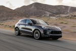 Picture of a driving 2015 Porsche Macan Turbo in Agate Gray Metallic from a front right three-quarter perspective