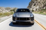 Picture of a driving 2015 Porsche Macan Turbo in Agate Gray Metallic from a frontal perspective