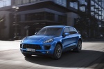 Picture of a driving 2015 Porsche Macan S in Dark Blue Metallic from a front left three-quarter perspective