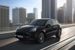Picture of a driving 2015 Porsche Macan Turbo in Agate Gray Metallic from a front left three-quarter perspective