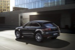 Picture of a driving 2015 Porsche Macan Turbo in Agate Gray Metallic from a rear left three-quarter perspective