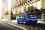 Picture of a driving 2015 Porsche Macan S in Dark Blue Metallic from a rear left perspective