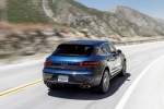 Picture of a driving 2015 Porsche Macan S in Dark Blue Metallic from a rear right perspective