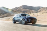 Picture of a driving 2015 Porsche Macan S in Dark Blue Metallic from a front right three-quarter perspective