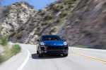 Picture of a driving 2015 Porsche Macan S in Dark Blue Metallic from a front right perspective