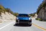 Picture of a driving 2015 Porsche Macan S in Dark Blue Metallic from a frontal perspective