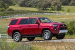 Picture of a driving 2018 Toyota 4Runner TRD Off Road in Barcelona Red Metallic from a front right three-quarter perspective