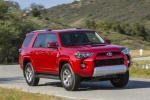 Picture of a driving 2018 Toyota 4Runner TRD Off Road in Barcelona Red Metallic from a front right perspective