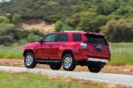 Picture of a driving 2018 Toyota 4Runner TRD Off Road in Barcelona Red Metallic from a rear left three-quarter perspective