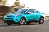 Picture of a driving 2018 Toyota C-HR in Radiant Green Mica from a front left three-quarter perspective