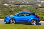 Picture of a driving 2018 Toyota C-HR in Blue Eclipse Metallic from a side perspective