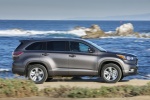 Picture of a driving 2014 Toyota Highlander Limited AWD in Predawn Gray Mica from a side perspective