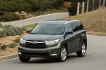 Picture of a driving 2014 Toyota Highlander Hybrid Limited AWD in Alumina Jade Metallic from a front left perspective