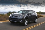 Picture of a driving 2014 Toyota RAV4 Limited in Magnetic Gray Pearl from a front left perspective