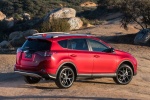 Picture of a driving 2016 Toyota RAV4 SE AWD in Barcelona Red from a rear right three-quarter perspective