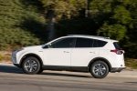 Picture of a driving 2016 Toyota RAV4 Hybrid XLE AWD in Super White from a left side perspective